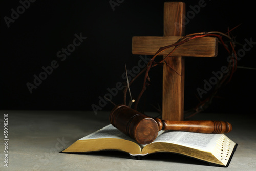 Judge gavel, bible, wooden cross and crown of thorns on grey table Fototapet
