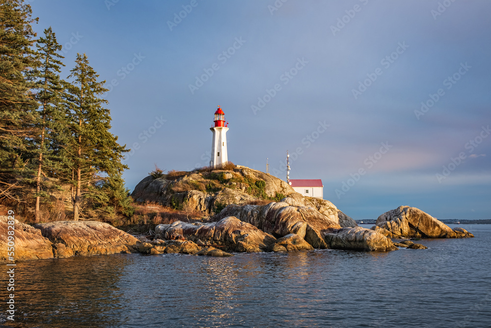 View of a Lighthouse on a rocky coast during a cloudy day, historic landmark Point Atkinson Lighthouse in West Vancouver