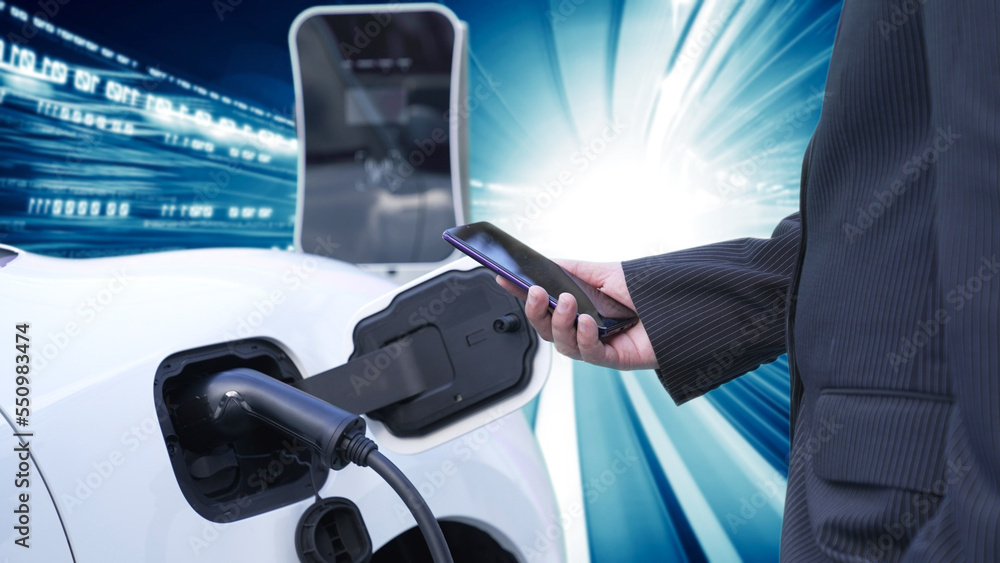 Progressive man charge electric car with power cable plug from charging ...