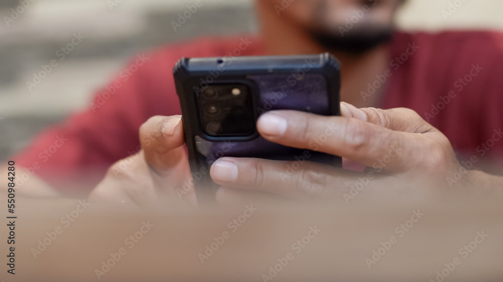 Cropped view of hand shot of man holding smartphone