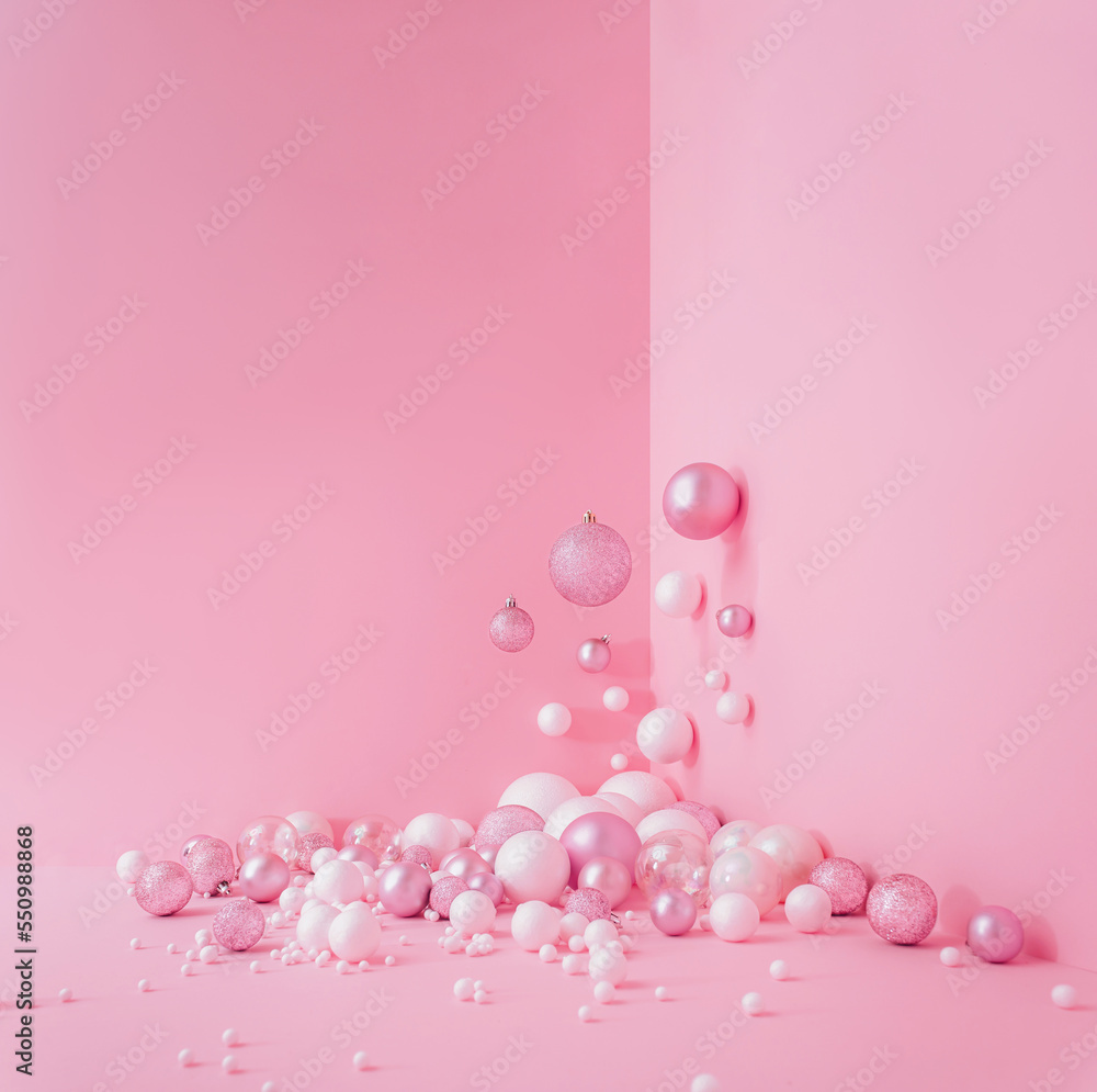 Creative Abstract Festive composition with Christmas design pink pastel color background and pink and white balls Minimal concept of New Year's and Christmas Holidays. Flat lay.