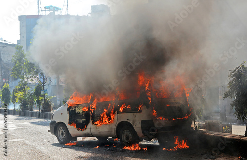Burning car Fire suddenly started engulfing all the car. Car on fire accident, out of focus with grain. © Vector photo gallery