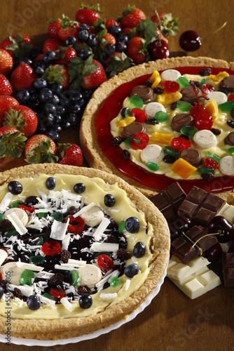 Sweet pizza-style dessert with chocolate, berries, jellies and sweets