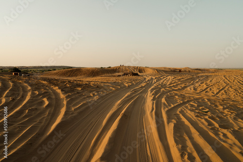 Car tyre marks on sand dunes of Thar desert, Rajasthan, India. Tourists arrive on cars to watch sun rise at desert , a very popular activity amongst travellers.