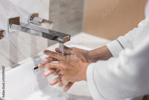 Close up of people washing hand with liquid soap carefully.