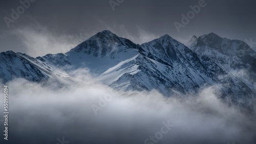 Caucasian mountains in the clouds. View from Kamunta village. Mountain Digoria, North Ossetia.