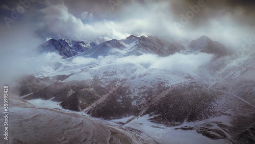 Caucasian Mountains in the clouds in winter. View from Kamunta village. Mountain Digoria  North Ossetia  Russia.