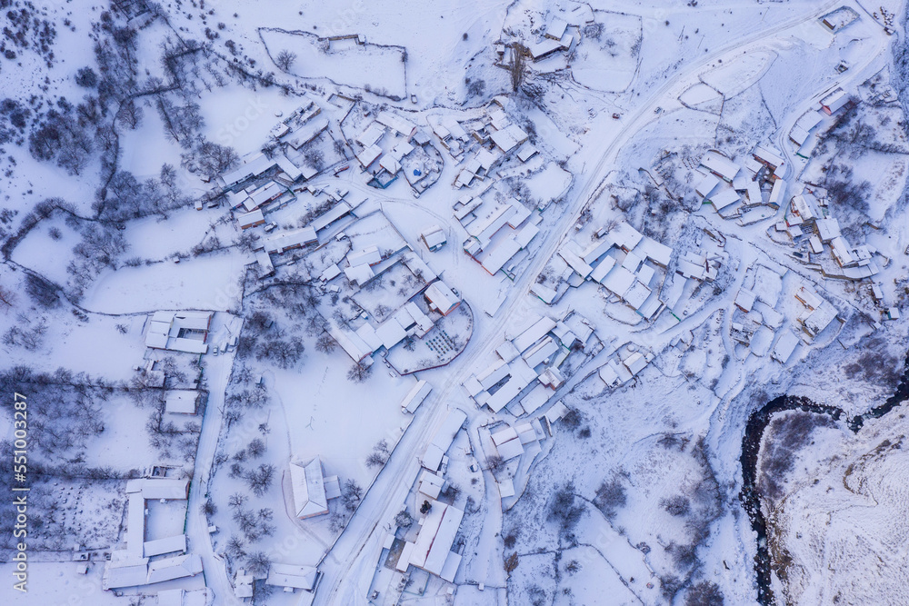 Aerial top view of covered with snow Makhchesk village on winter day. Mountain Digoria, North Ossetia, Russia. Aerial top view of covered with snow Makhchesk village on winter day. Mountain Digoria, North Ossetia, Russia.