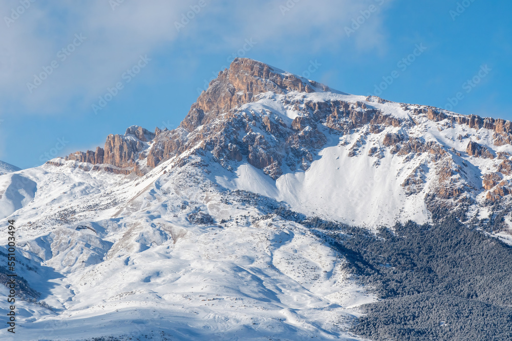 Mount Muldzugi-Barzond of Skalisty Mountain Range on sunny winter day. Digoria, North Ossetia, Russia.