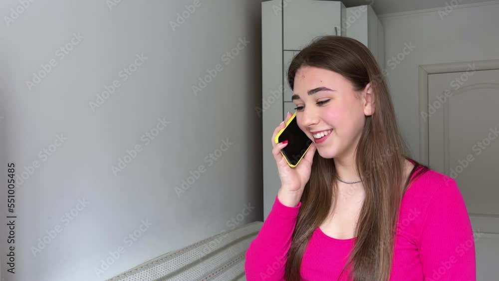 Young woman happily talking on the phone Beautiful young woman talking on the phone in white blouse and shorts, long hair, brunette, smiling happily. Social networks, online chat Fashion style Young woman happily talking on the phone Beautiful young woman talking on the phone in white blouse and shorts, long hair, brunette, smiling happily. Social networks, online chat Fashion style