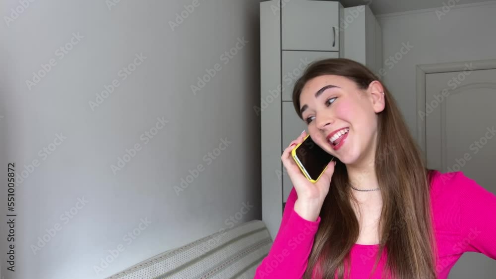 Young woman happily talking on the phone Beautiful young woman talking on the phone in white blouse and shorts, long hair, brunette, smiling happily. Social networks, online chat Fashion style Young woman happily talking on the phone Beautiful young woman talking on the phone in white blouse and shorts, long hair, brunette, smiling happily. Social networks, online chat Fashion style