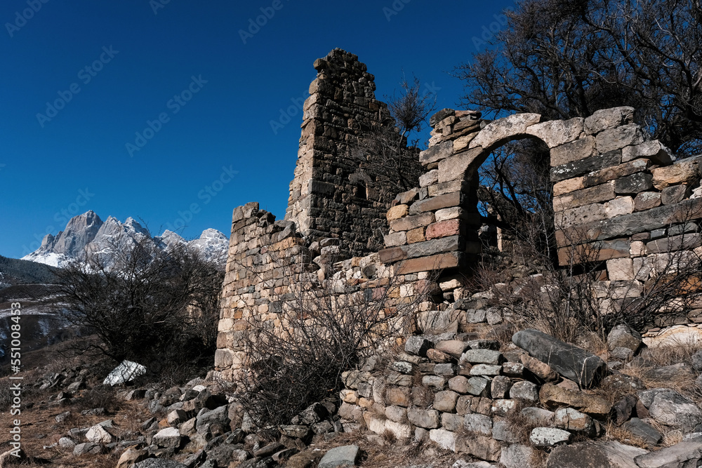 Remains of medieval Ingush settlement near by temple Tkhaba-Erdy on sunny winter day. Ingushetia, Caucasus, Russia.