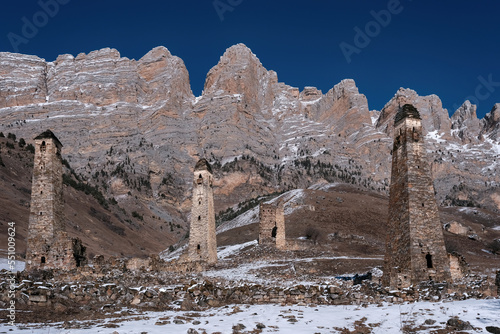 Old Ingush towers complex Niy on sunny winter day. Ingushetia, Caucasus, Russia. photo