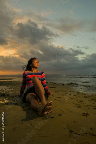 Asian girl on the beach at sunset