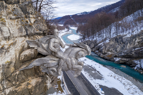 Aerial view of Nyhas Uastyrji monument, Ardon river and Transcaucasian Highway on cloudy day. Alagir gorge, North Ossetia, Russia. photo