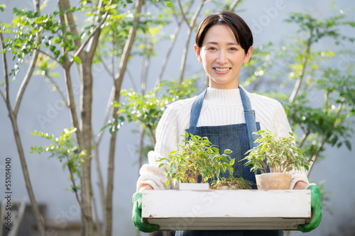 Image of a woman who enjoys gardening or a sales clerk Looking at the camera