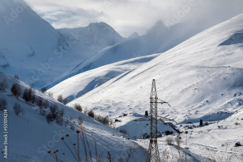 Caucasian winter landscape. View of Mamikhdon river valley from Lisri village on sunny day. North Ossetia, Russia.