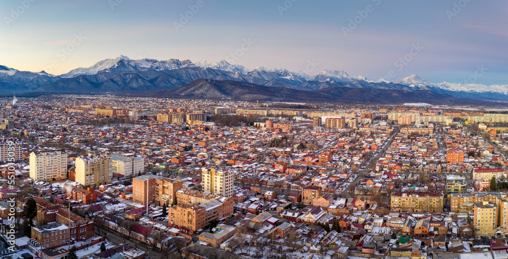 Panoramic aerial view of Vladikavkaz and Caucasian Mountains at sunrise. North Ossetia, Russia.
