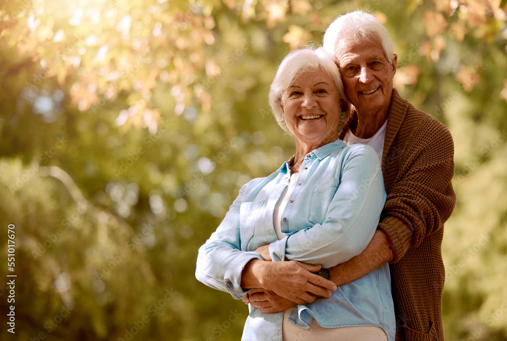 Nature, hug portrait and senior couple with mockup embracing outdoor in a park together during retirement. Happy, romance and love with a mature man and woman hugging in a garden with plants or trees Nature, hug portrait and senior couple with mockup embracing outdoor in a park together during retirement. Happy, romance and love with a mature man and woman hugging in a garden with plants or trees