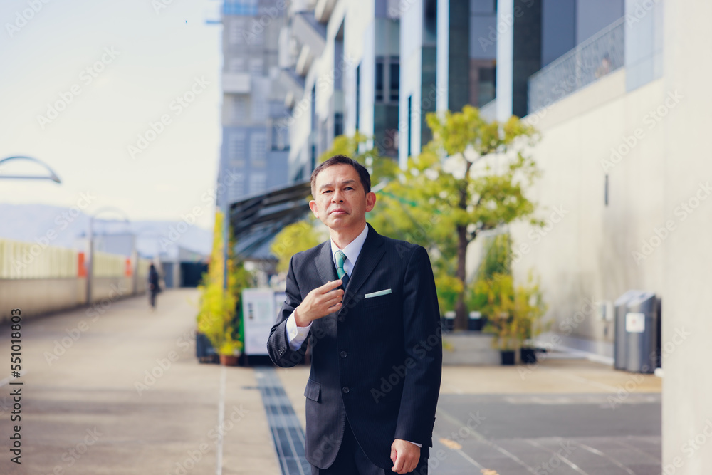 Middle-aged Asian man in black business suit at Kyoto station, Japan. Middle-aged Asian man in black business suit at Kyoto station, Japan.