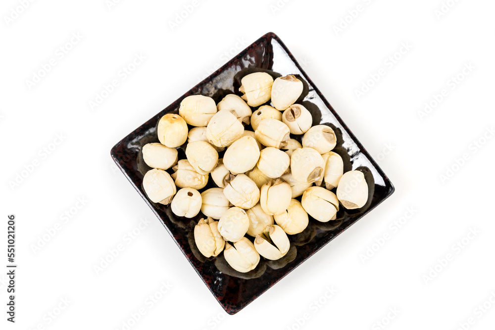 Lotus seeds in a black tray isolated over white background top down view Lotus seeds in a black tray isolated over white background top down view
