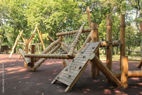 Wooden modern ecological safety children outdoor playground equipment in public park. Nature architecture construction playhouse in city. Children rest and childhood concept. Idea for games on air.