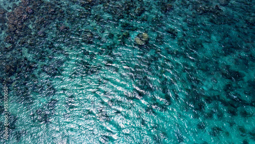 tropical coral reef from above drone shot turquoise transparent water bali indonesia