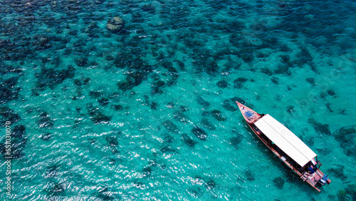 tropical coral reef from above drone shot with boat transparent water bali indonesia © matthias