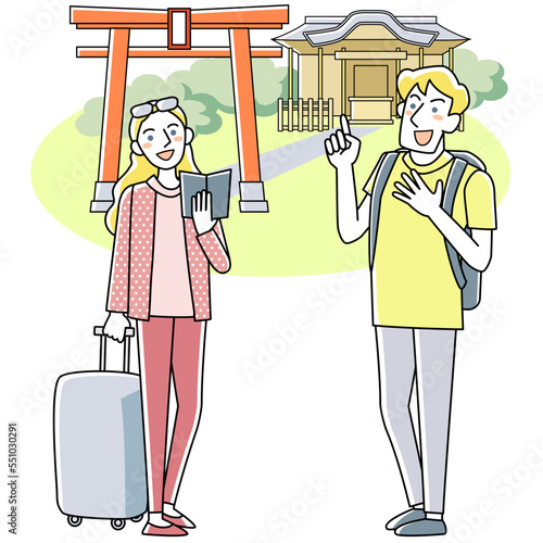 ガイドブックを手に神社を見る外国人観光客の男女