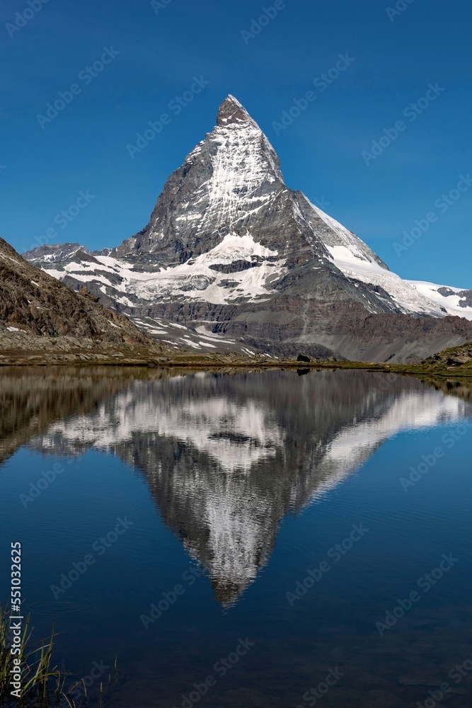 The Matterhorn Mountain reflects at a lake at the Alps in Switzerland