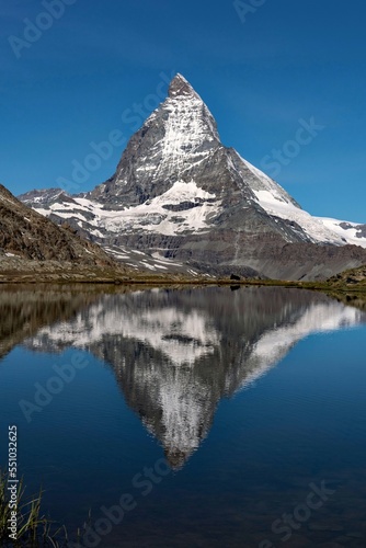 The Matterhorn Mountain reflects at a lake at the Alps in Switzerland 