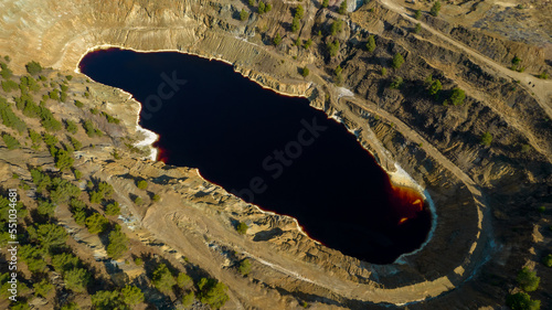 Drone aerial of copper mine with red toxic water. Environmental pollution land contamination photo