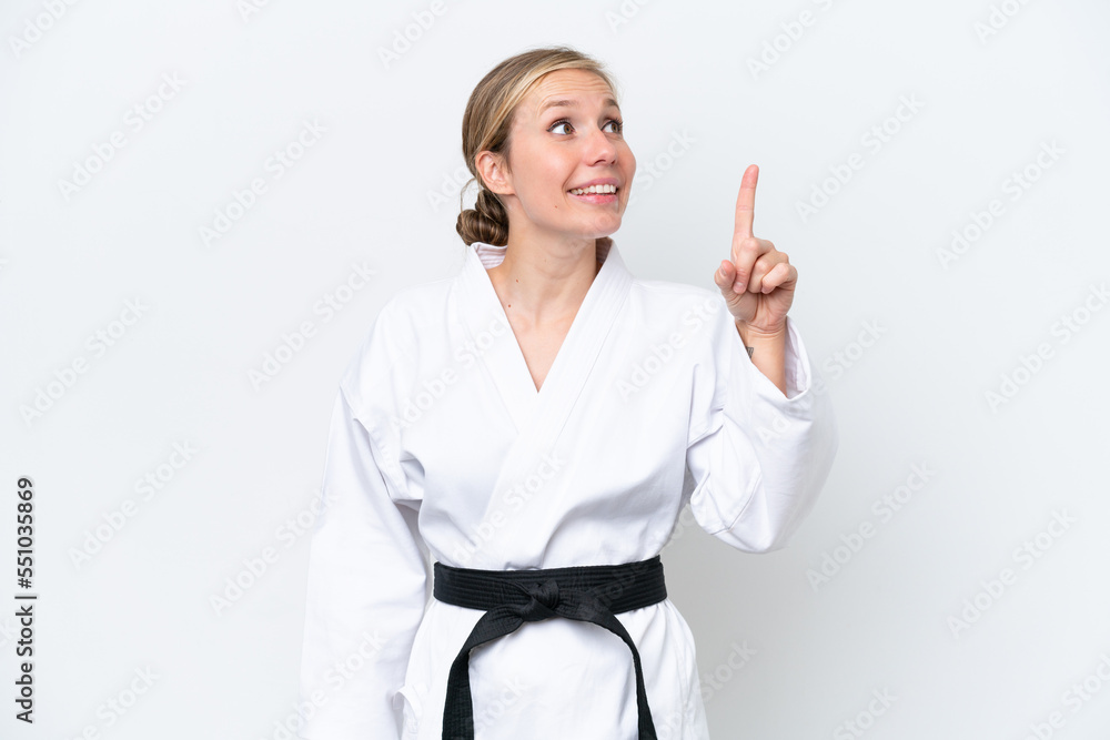 Young caucasian woman doing karate isolated on white background pointing up a great idea Young caucasian woman doing karate isolated on white background pointing up a great idea