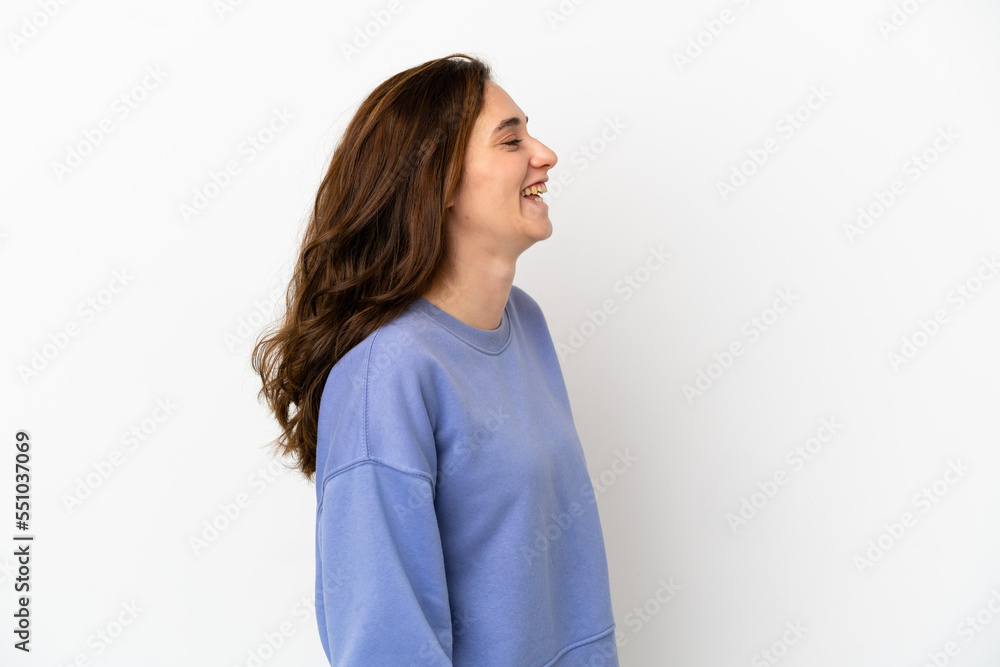 Young caucasian woman isolated on white background laughing in lateral position Young caucasian woman isolated on white background laughing in lateral position