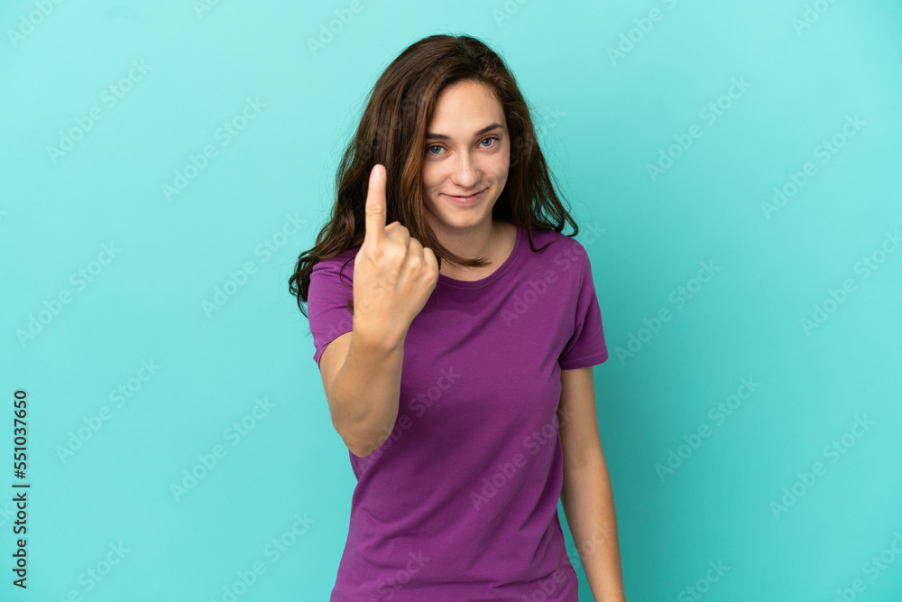 Young caucasian woman isolated on blue background doing coming gesture Young caucasian woman isolated on blue background doing coming gesture