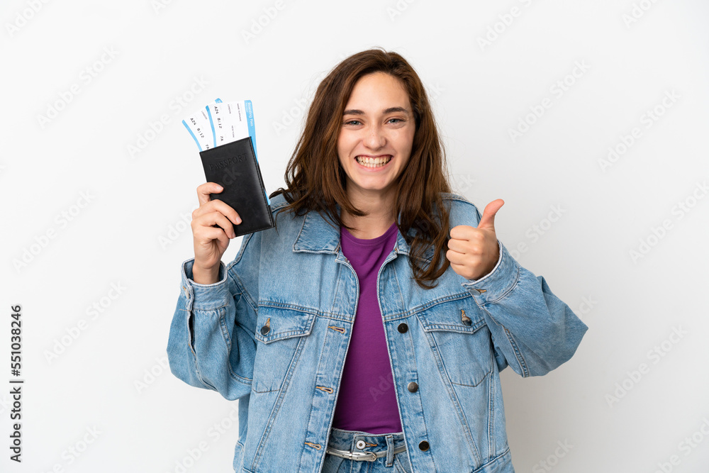 Young caucasian woman isolated on white background in vacation holding a passport and plane with thumb up Young caucasian woman isolated on white background in vacation holding a passport and plane with thumb up