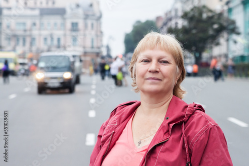 Portrait of beautiful aged woman in the street. Selective soft focus on eyes.