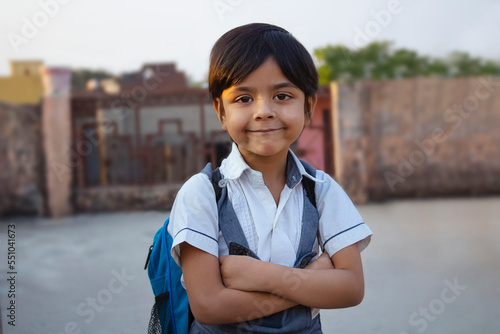 Rural Indian school girl standing crossed arms photo