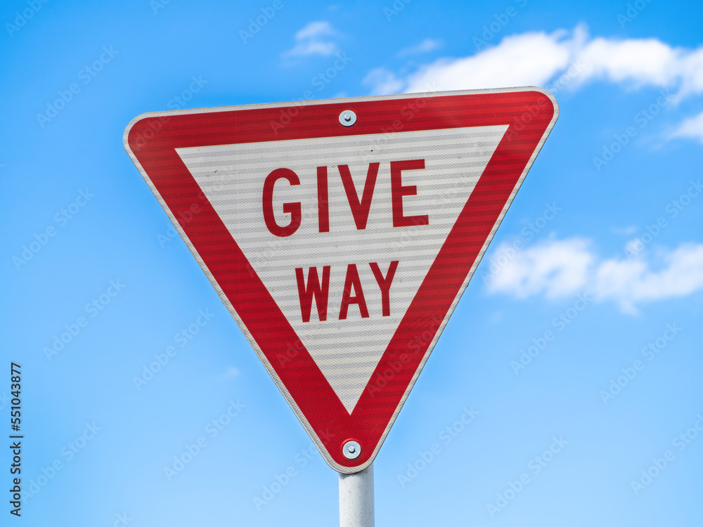 Give way road sign on blue sky background Give way road sign on blue sky background