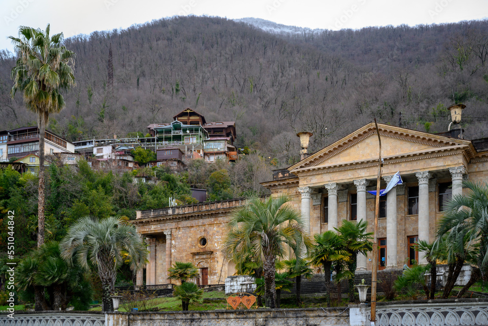 An antique-style building on the background of mountains in the city of Gagra, Abkhazia, in winter
