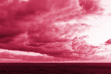 Foto auf Acrylglas Pantone 2023 Viva Magenta Trendy color of the year 2023. Sky with rain clouds toned in viva magenta color.sky abstract background, beautiful cloudscape, on the heaven, view over white fluffy clouds, freedom concept  © Yulia