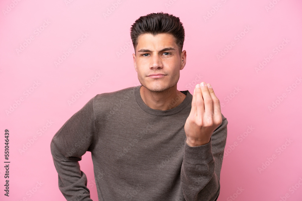 Young caucasian man isolated on pink background making Italian gesture Young caucasian man isolated on pink background making Italian gesture