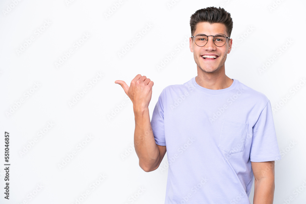 Young caucasian man isolated on white background pointing to the side to present a product Young caucasian man isolated on white background pointing to the side to present a product