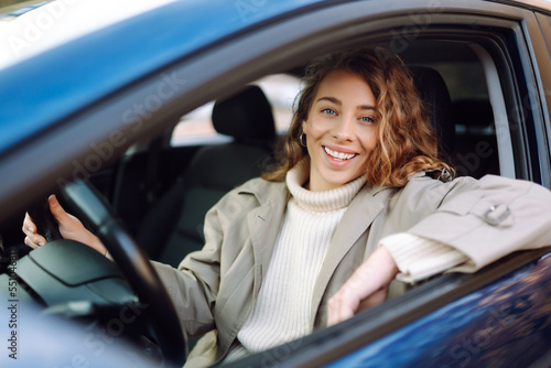 Quadro em tela Pretty woman driver smiling to you from the  car