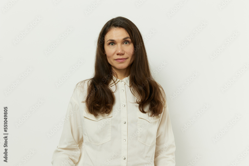 portrait of a beautiful happy attractive adult woman in a white shirt on a white background