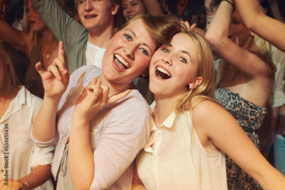 Rock, dance night and friends at a concert, disco event or band performance in the crowd. Happy party, music smile and portrait of dancing women at a rave music festival, show energy and celebration Rock, dance night and friends at a concert, disco event or band performance in the crowd. Happy party, music smile and portrait of dancing women at a rave music festival, show energy and celebration