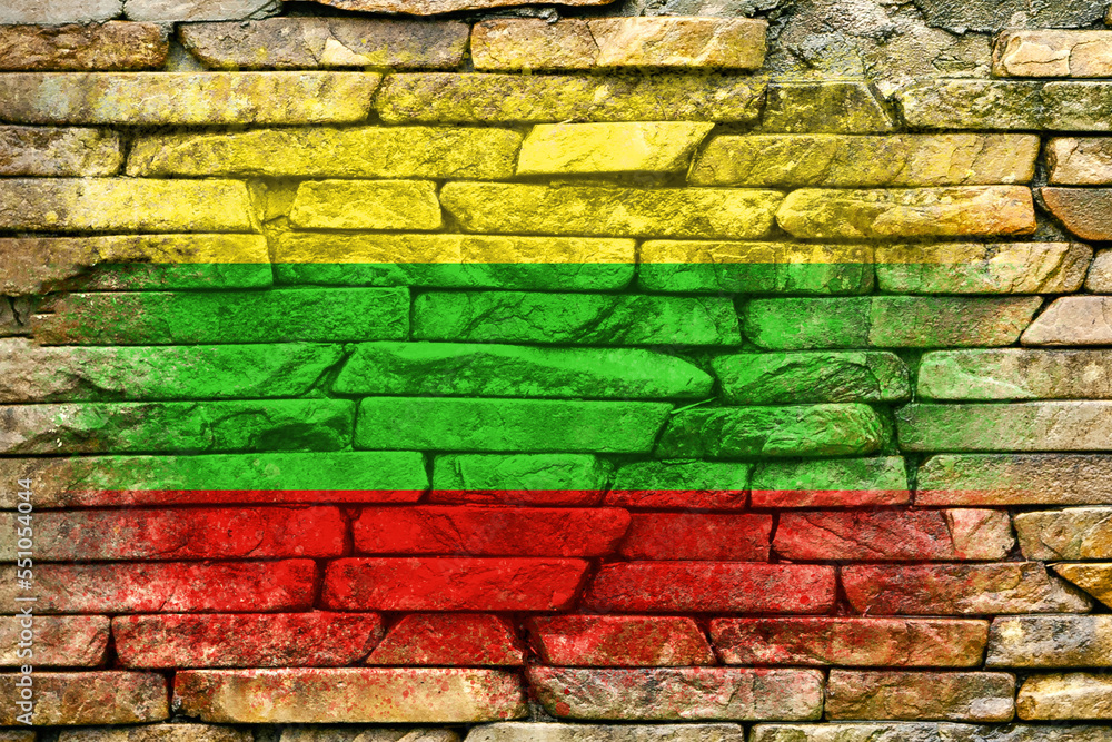 Flag of Lithuania. Flag is painted on a stone wall. Stone background. Copy space. Textured background Flag of Lithuania. Flag is painted on a stone wall. Stone background. Copy space. Textured background