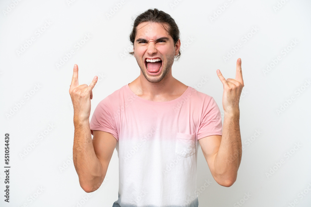 Caucasian handsome man isolated on white background making horn gesture Caucasian handsome man isolated on white background making horn gesture