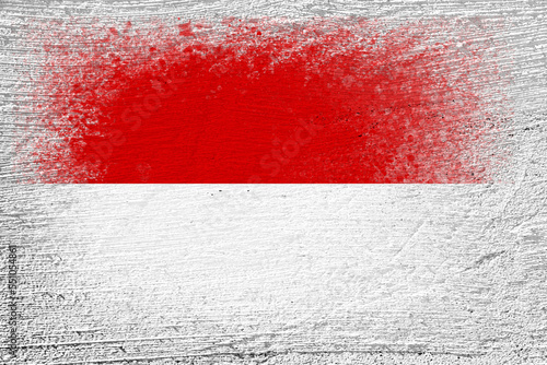 Flag of Monaco. Flag is painted on a cement wall. Cement background. Plastered surface. Copy space. Textured background