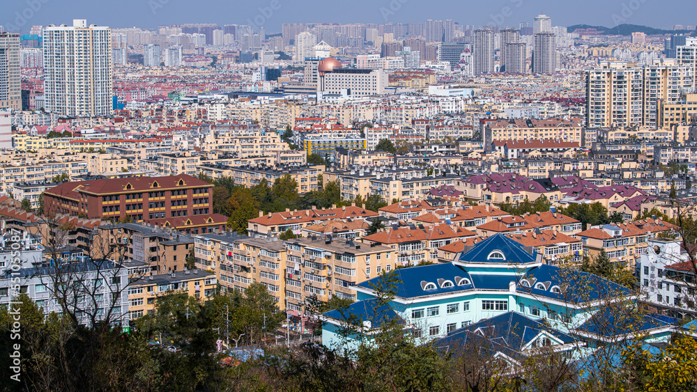 Panorama of the Bird's eye view of orange roofs and cityscape, Qingdao, China.